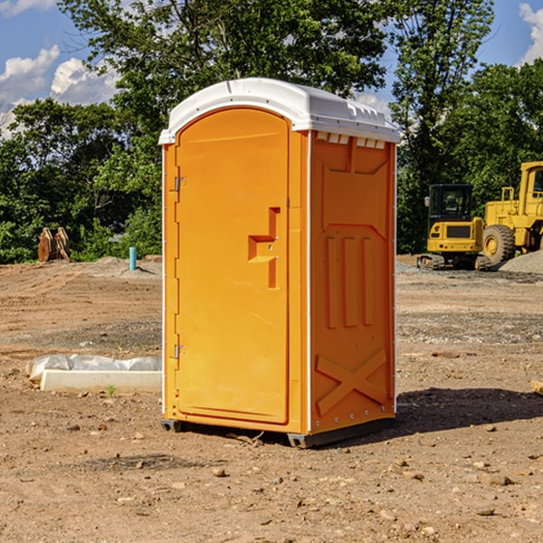 what is the cost difference between standard and deluxe portable restroom rentals in Saxon